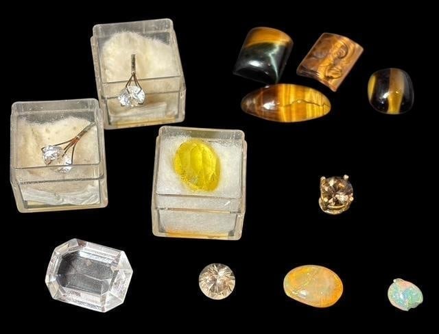 Lot of Assorted Cabochons Including Smoky Quartz, Opal, Tiger's Eye, Spinel: Lot of twelve assorted cabochons. Smoky quartz, quartz, tiger eye, opal, fire opal and synthetic spinel.