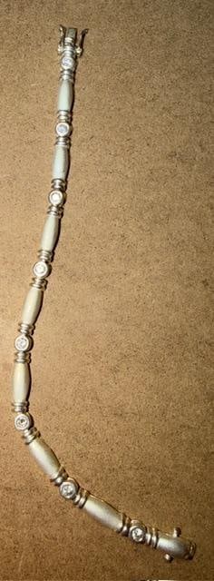 Sterling and CZ Bracelet: Sterling 8" bracelet with CZ type stones as spacers. Marked .925. Weighs 13g.