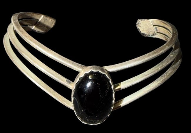 Sterling and Onyx Cuff Bracelet: Sterling and onyx stone cuff bracelet. Marked sterling. Measures 6" around with a 1.5" cuff opening.