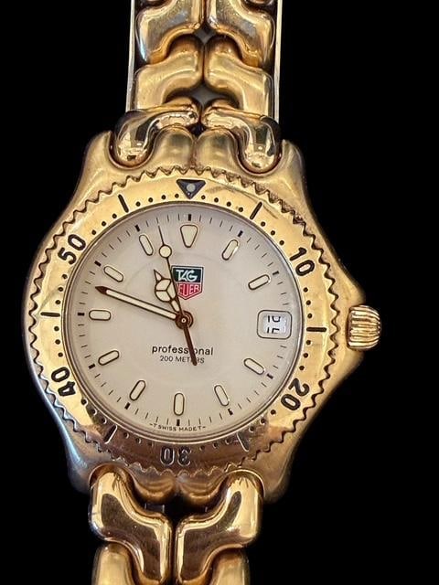 Tag Heuer Gold Tone Mens Watch: Gold tone men's watch by Tag Heuer. Number WG 1130-0, and marked professional. Watch face measures 1.5" x 1.75".