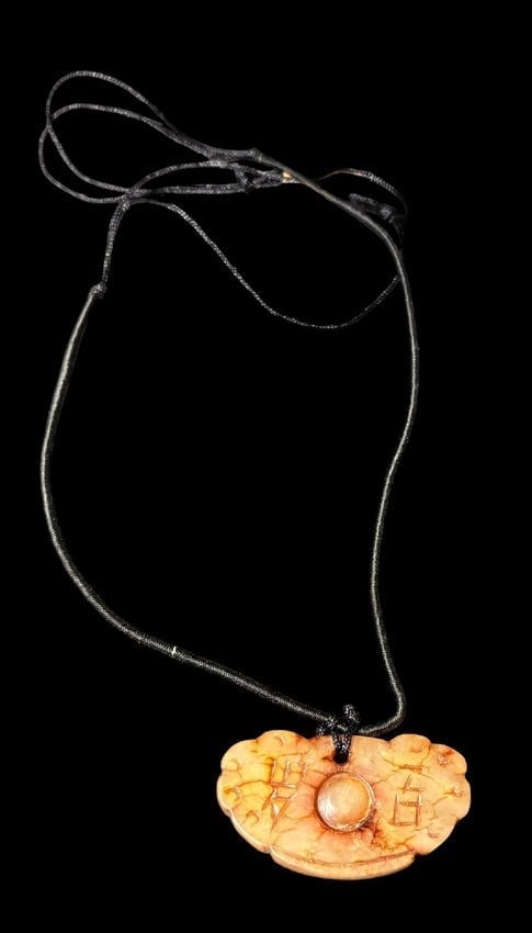 Handcarved Jade Pendant on Cord: Hand carved jade pendant on a 18" cord. Pendant measures 1.75" x 1".