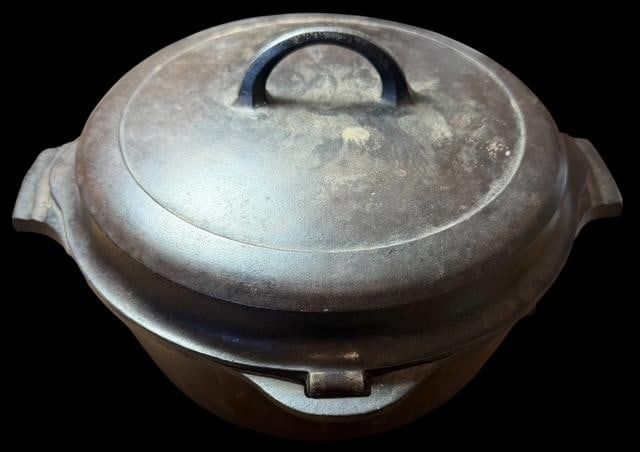 Griswald Cast Iron Dutch Oven - Number 8: Griswold cast iron Dutch oven number 8. Logo number 2568. Has hinged lid design. Measures 13" wide and 7.5" tall with lid on.