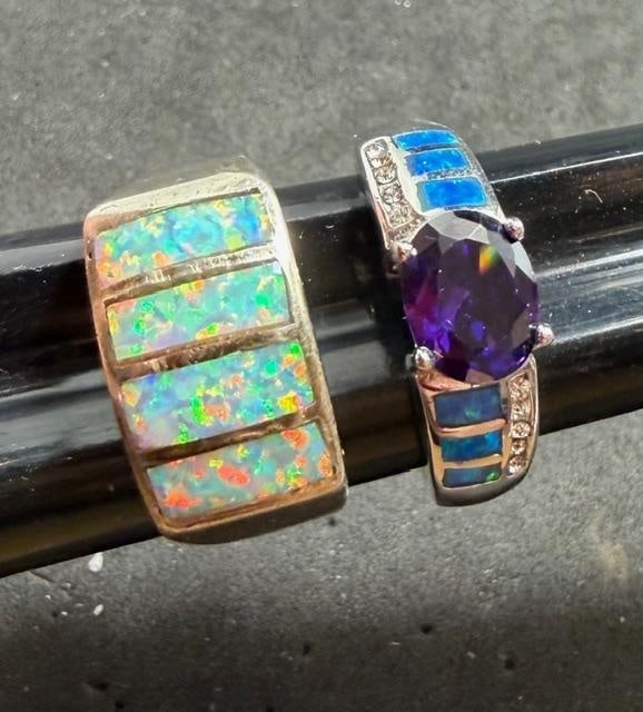 Pair of Opal and Sterling Rings: Pair of opal and sterling rings. One has an amethyst center stone. Total weight 15g. Both are size 9.5.