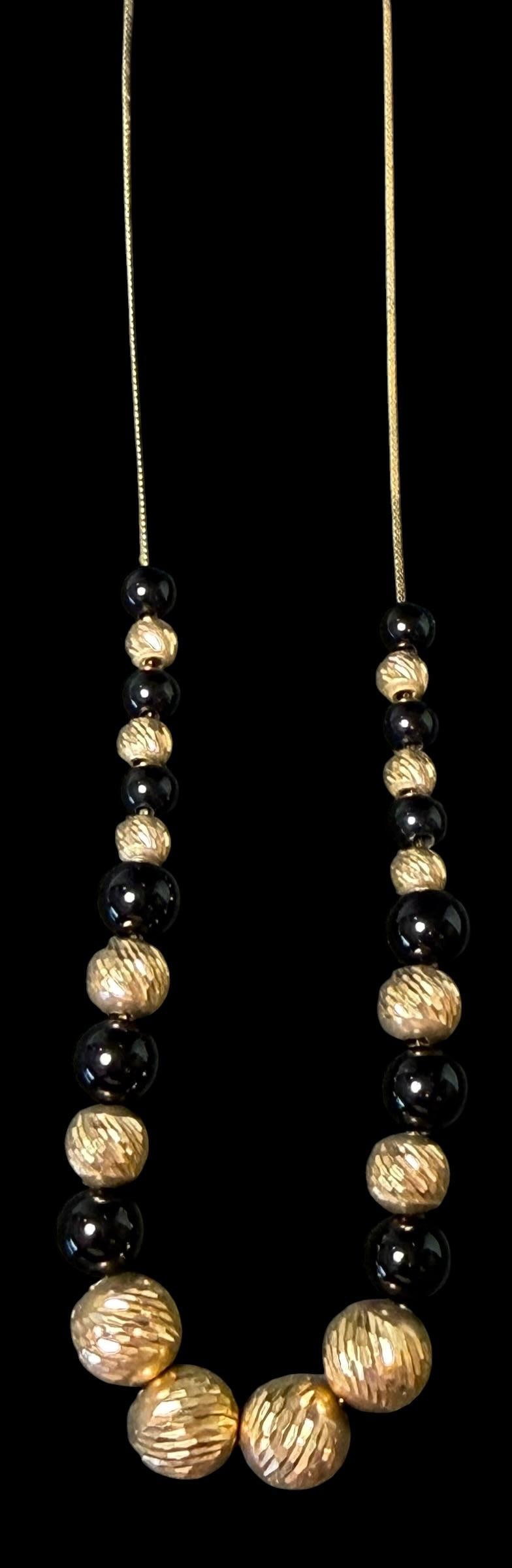 14K Gold Necklace with Goldtone and Black Beads: 14K gold fine chain with goldtone and black beads. Chain marked 14K and Italy. Measures 19" and total weight is 9.1g.