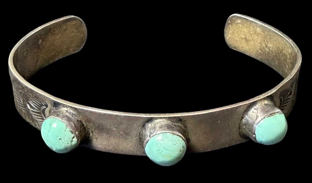 Native American Hallmark Signed Turquoise and Sterling Cuff Bracelet: Native American signed sterling and turquoise stone cuff bracelet. Signed with silversmiths hallmark sign. Measures 5.75" with a 1.25" cuff opening. Weighs 15g.