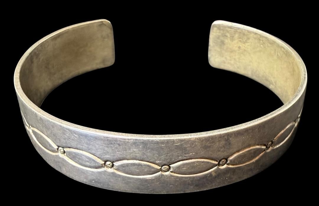 Native American Navajo Sterling Cuff Bracelet: Native American sterling stamped design cuff bracelet. Measures 6.5" around with a 1" cuff opening. Weighs 25g. Marked sterling.