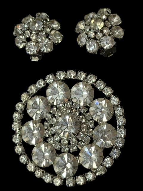 Mid Century Kramer Rhinestone Brooch and Clip Earring Set: Mid century Kramer rhinestone brooch and clip earring set. All pieces are marked. Brooch measures 2" across. Earrings measure 1" across. Nice clear rhinestones.