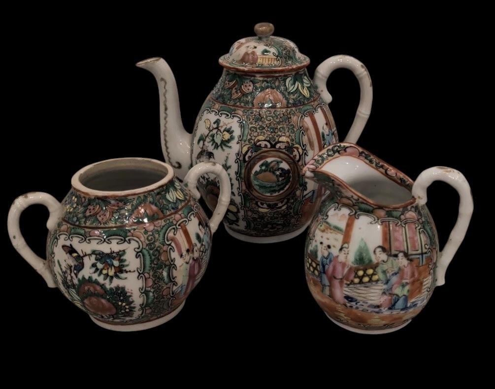 Chinese Porcelain Tea Set: Chinese Porcelain tea set. Tea pot measures 7" across by 7" high. Sugar bowl missing lid, measures 5.5" x 4". Creamer measures 4" x 4". Marked China.