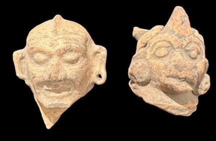 Pair of Pre-Columbian Carved Faces 1200 CE: Pair of Pre Columbian, ca 1200 AD, carved faces with excellent detail including hole in ear lobe. One appears human and the other animal or mystical. Each measure 1.5". Museum of Man San Diego, Ca.