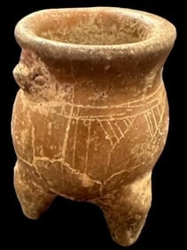 Pre-Columbian Tripod Pot 1200 CE: Pre-Columbian, ca 1200 AD, tripod pot with animal carved on side. Measures 2". Museum of Man San Diego, Ca.