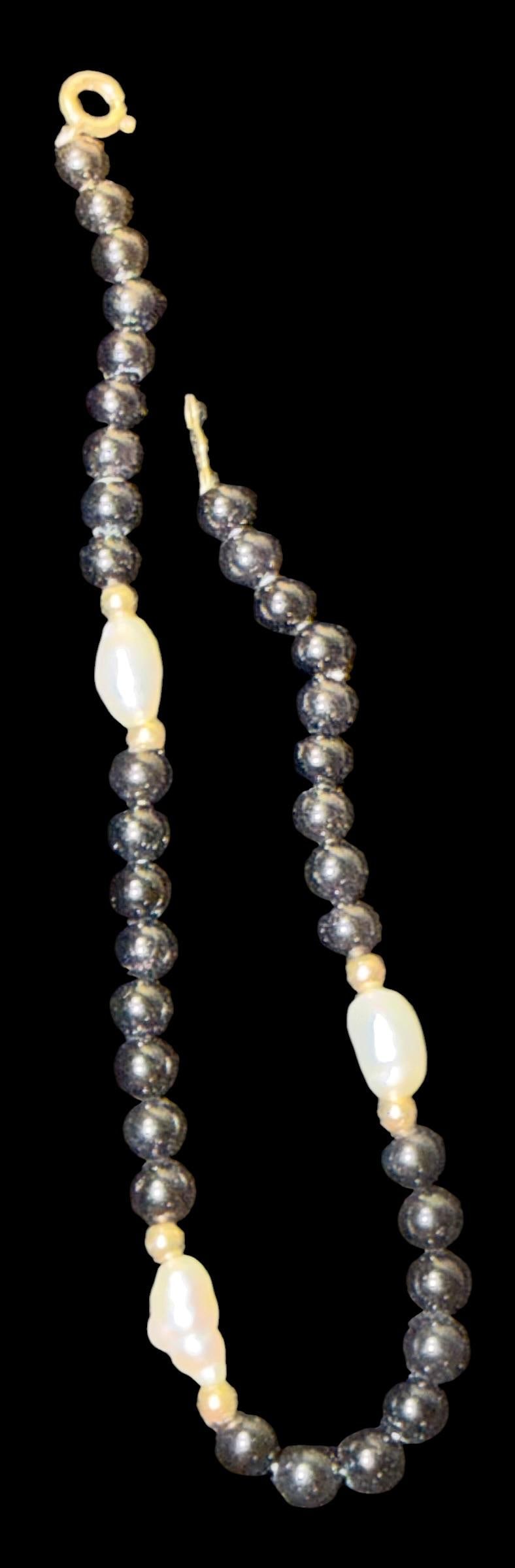 Pearl and Onyx Tennis Bracelet: Pearl and onyx bead tennis bracelet. Has 14k yellow gold clasp. Measures 7". Total weight 3.5g.