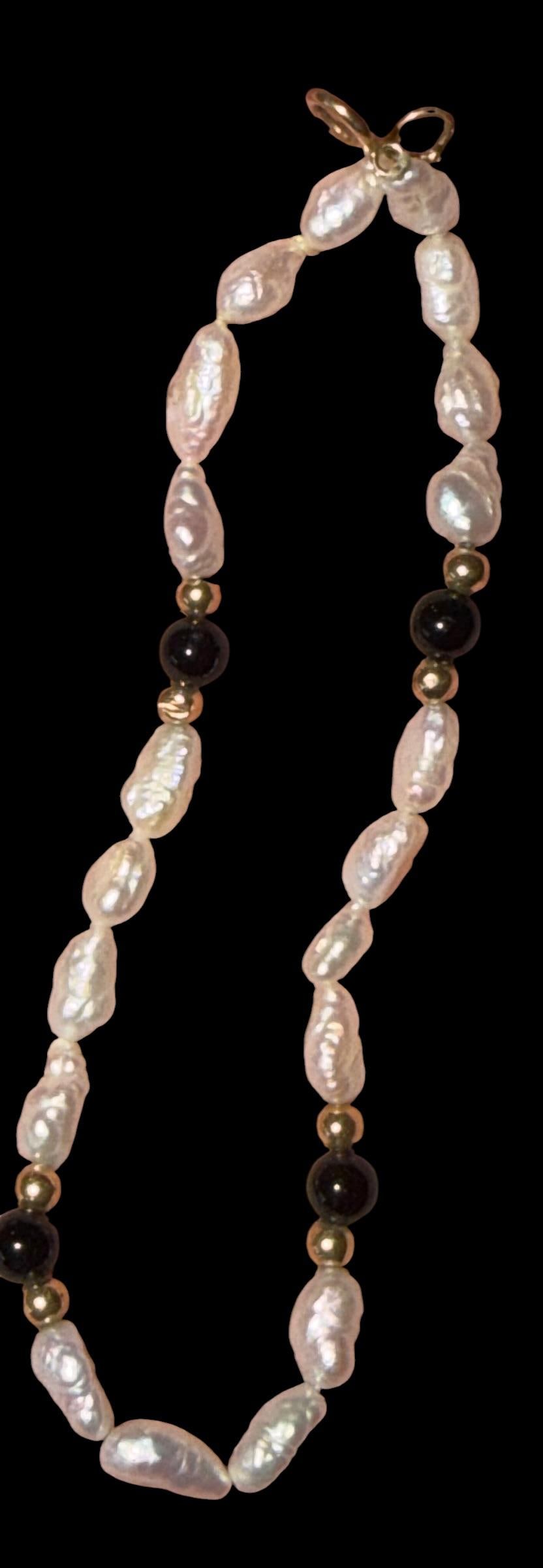 Tennis Bracelet with Pearls, 14K Gold Beads and Onyx Beads: Tennis bracelet with freshwater pearls, 14k gold beads and onyx beads. Clasp is also 14k gold. Measures 7". Weighs 3.2g.