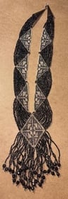 Art Deco American Beaded Necklace: American Beaded Necklace. Sterling tips. Black and clear beads with a 5" center design. Measures 21".