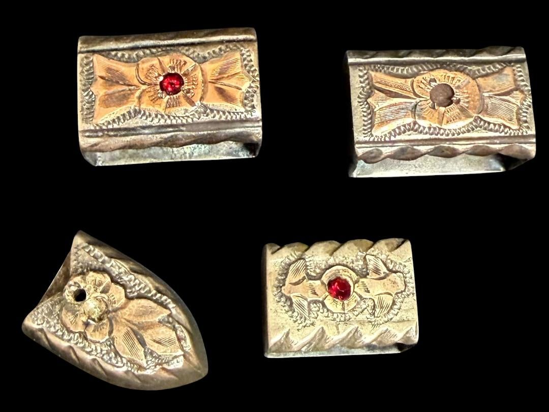 Four Pieces of a Ranger Belt: Four pieces of a ranger belt. Tested sterling with brass/gold tone accents and ruby stone inset. Two pieces are missing the rubies. Each piece measures 1" x .25". Weighs 28g. No buckle.