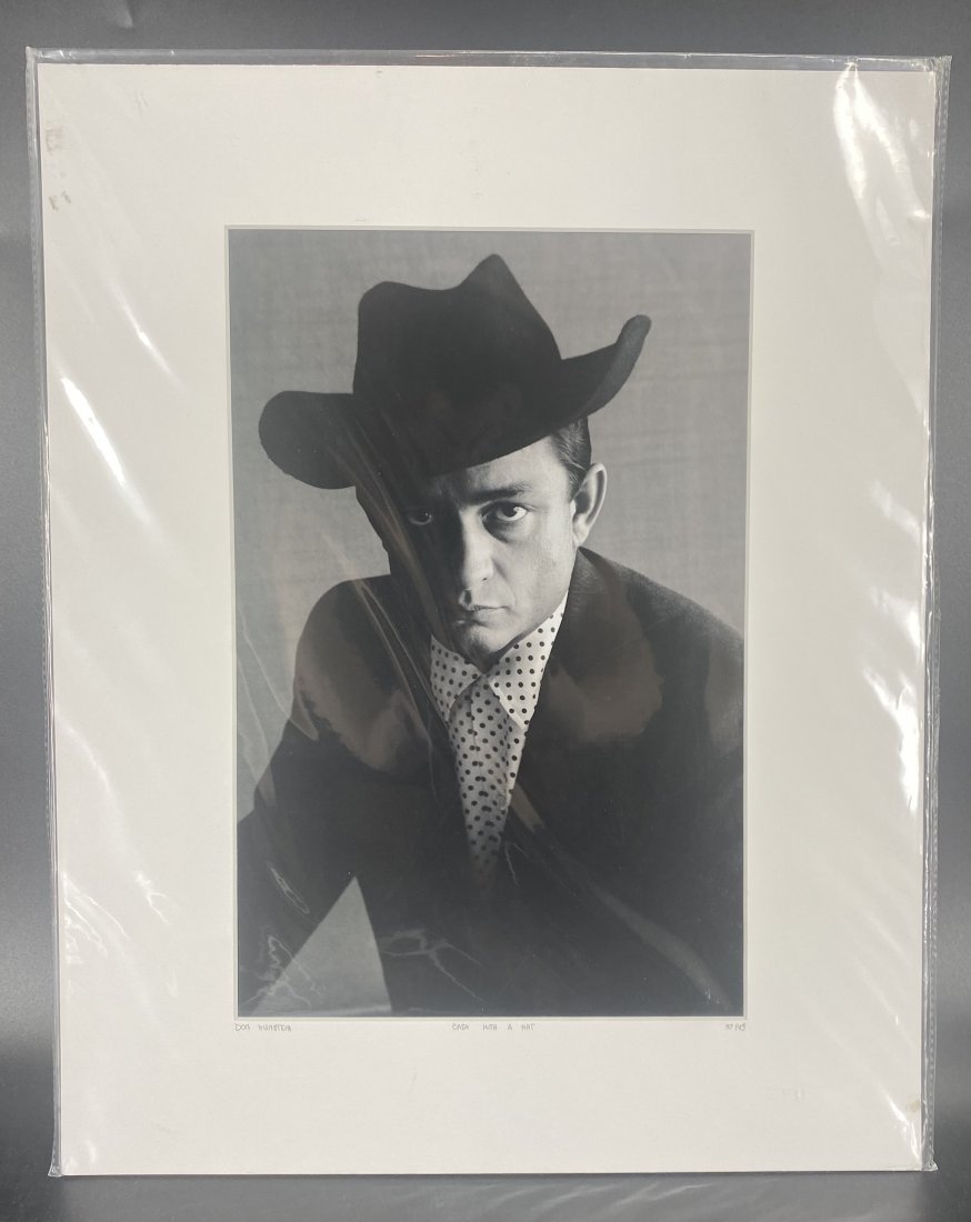 Don Hunstein Cash With a Hat L/E Photograph COA: Photographer: Don Hunstein Title: Cash with a Hat Celebrity: Johnny Cash Certificate of Authenticity from YellowKorner affixed to the back Matted Dimensions: 16 x 20 Protected with Clear Mylar Sleeve 
