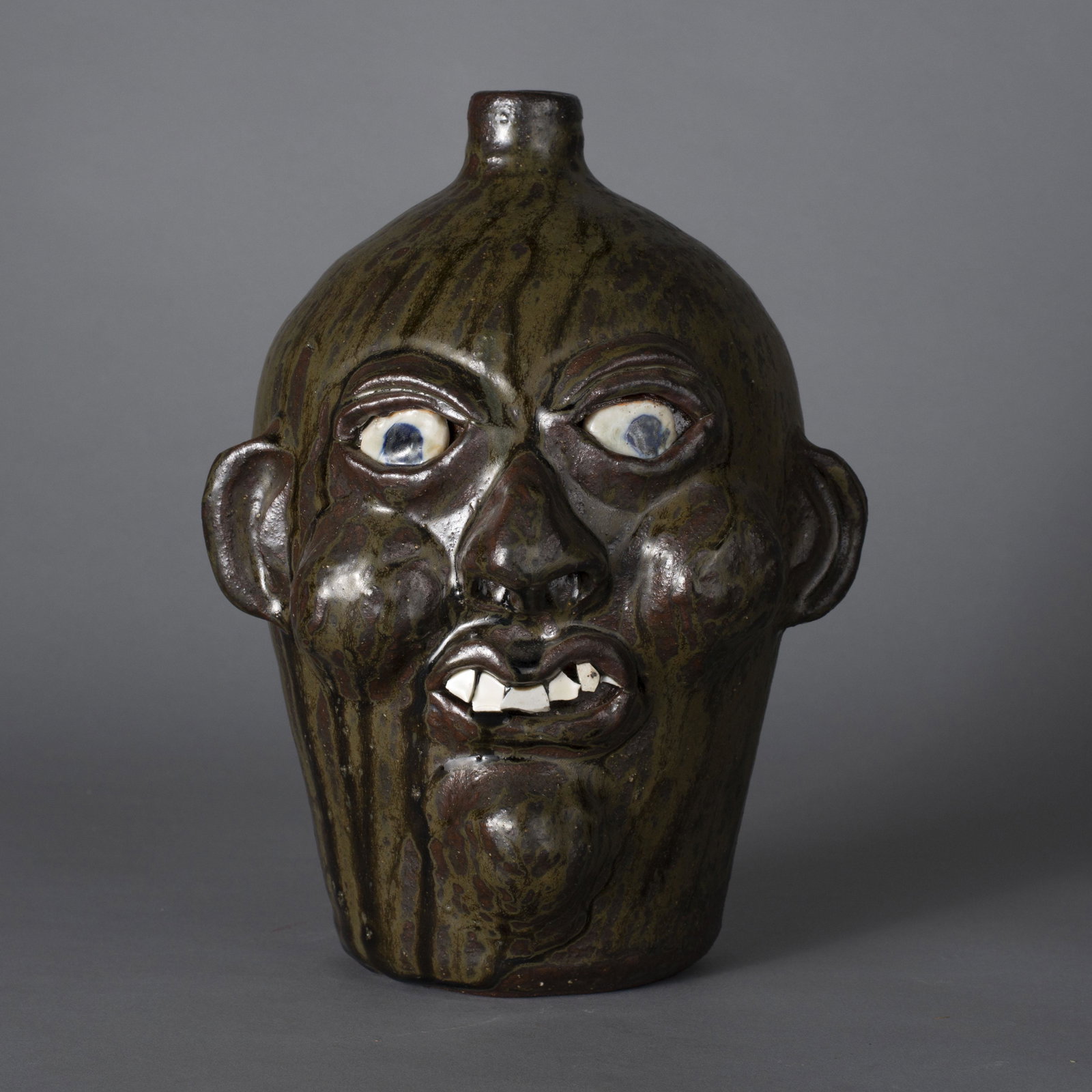 Grace Nell Hewell face jug 1998: a Grace Nell Hewell face jug dated 1998. china teeth clay eyes. Great glaze drips. Signed on bottom. 11"