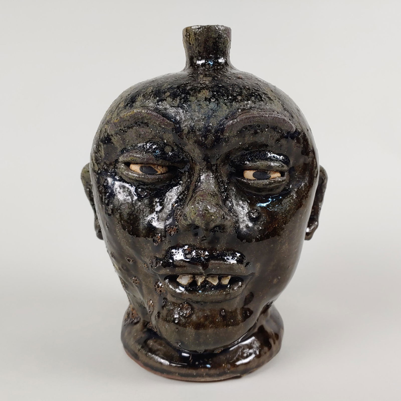 Lanier Meaders Rock tooth Face jug: Lanier meaders rock tooth face jug. Very nice glaze clay eyes rock teeth. Condition is excellent. 10.5"