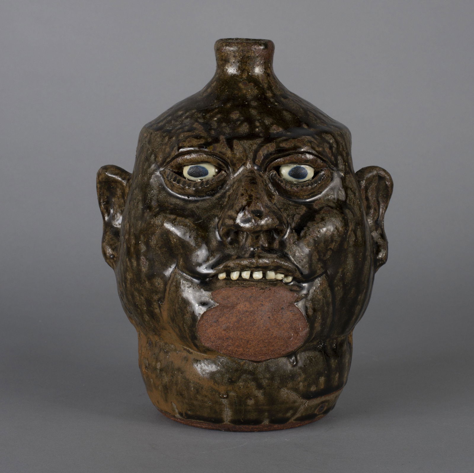 Lanier Meaders face jug chin loss: Lanier Meaders face jug with a kiln disaster chin loss. No other cracks or condition issued. Great glaze and great features. Clay eyes clay teeth. 10.5"