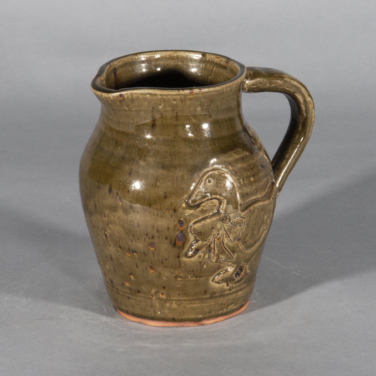 Jack Meaders Applied Duck Pitcher: Signed on bottom Jack Meaders. This pitcher has an applied duck on the side with a very nice alkiline glaze finish. Height 7"
