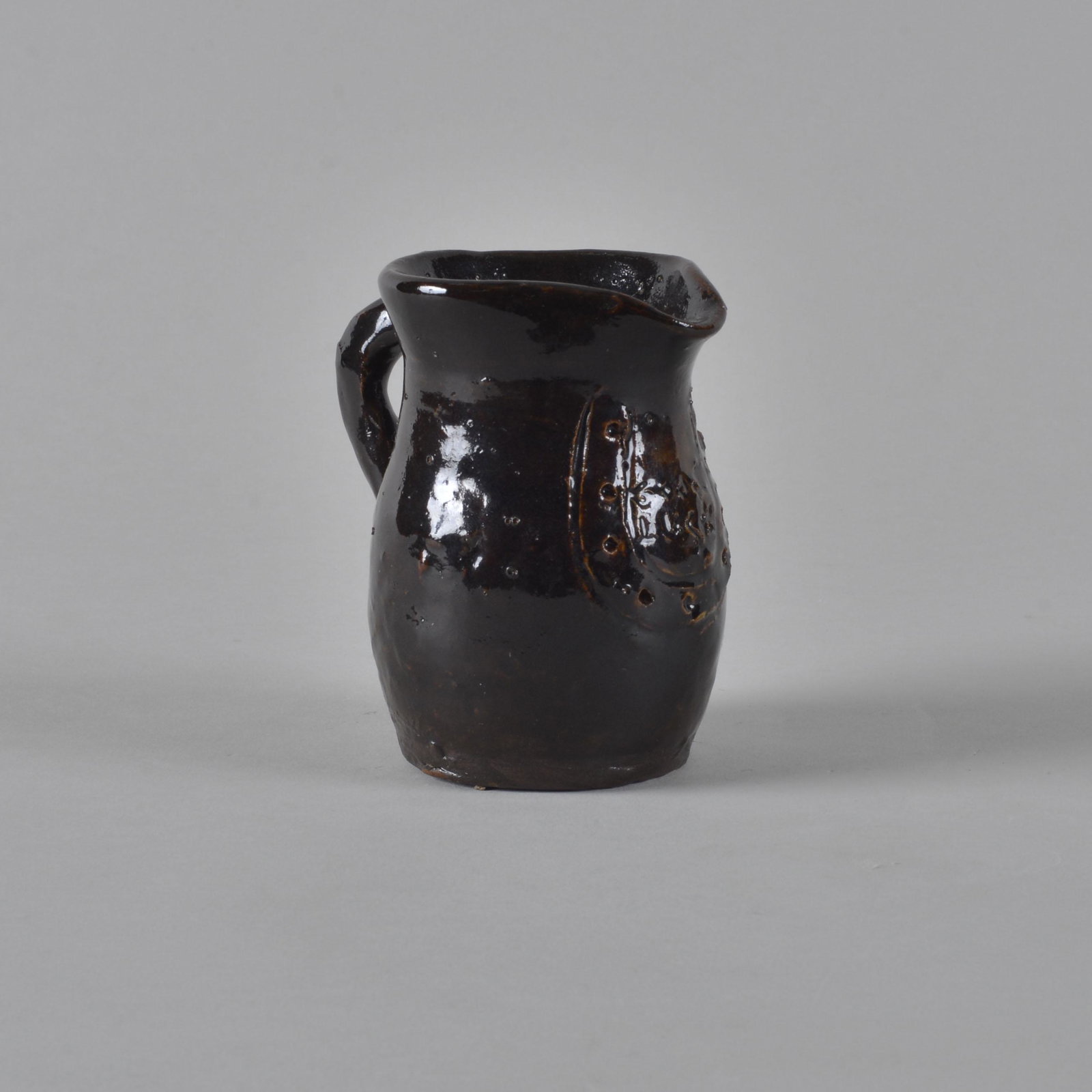 Marie Rogers Pitcher w/ horseshoe: Marie Rogers (1922-2010) was a Meansville, Georgia folk artist and one of the first female pot throwers in Georgia. Starting in earnest in 1974 height 3.5"