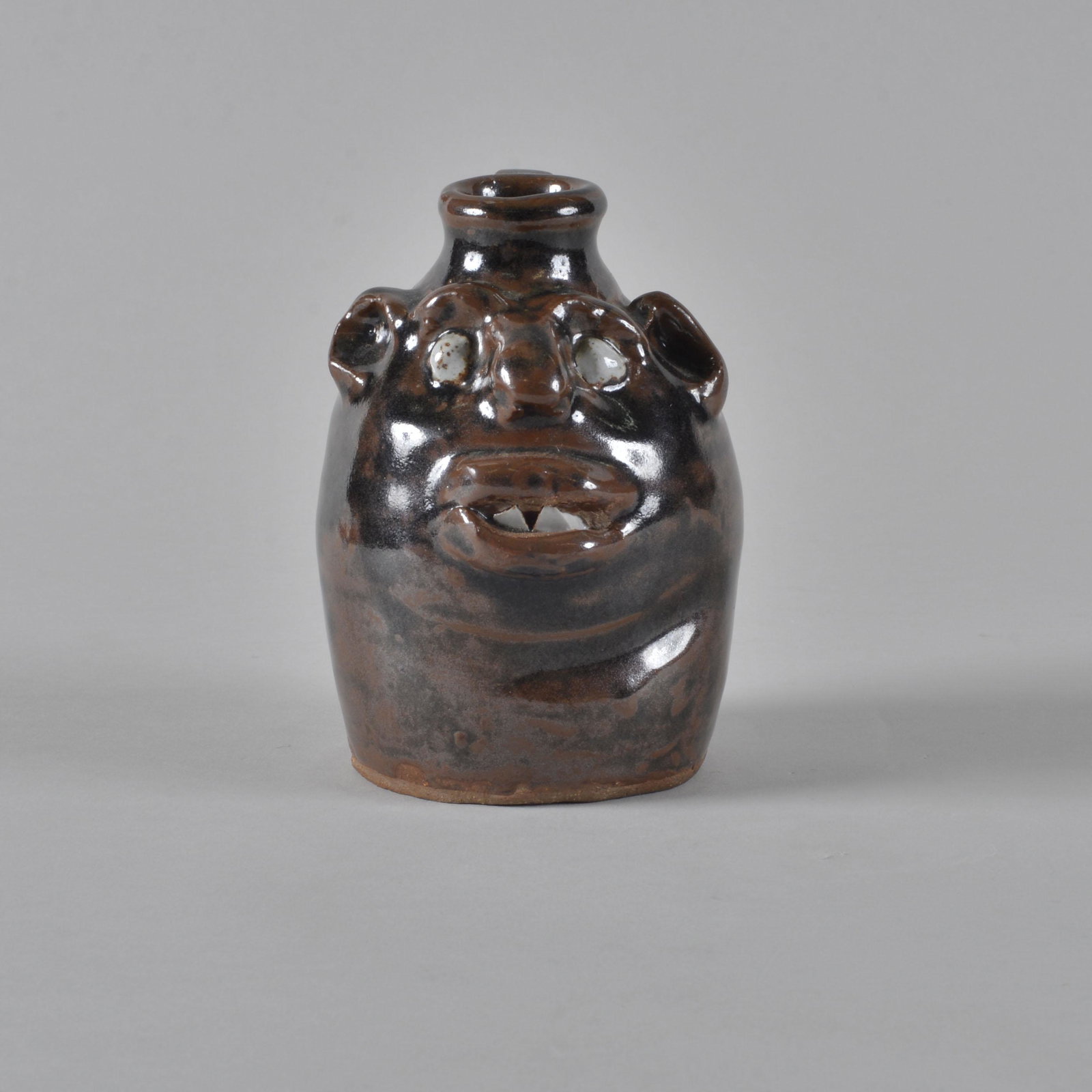 Marie Rogers Face Jug: Marie Rogers (1922-2010) was a Meansville, Georgia folk artist and one of the first female pot throwers in Georgia. Starting in earnest in 1974 height 4.5"