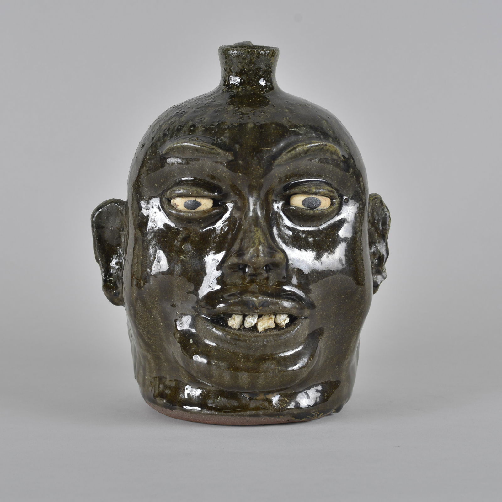 Lanier Meaders Rock Tooth Face Jug: Lanier Meaders rare rock tooth face jug by fantastic alkaline glaze. Condition is EXCELLENT. Height 10"