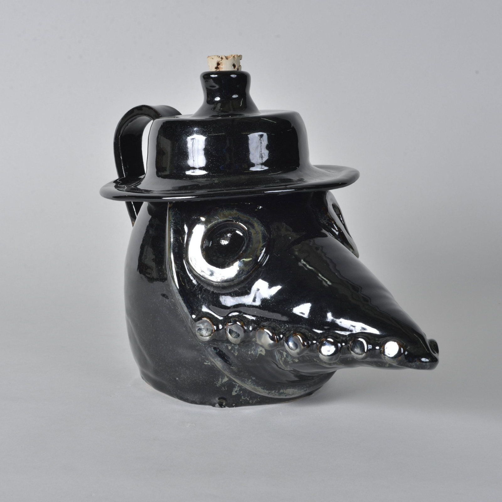 Abbot Pottery Crow face jug: folk art crow with long mouth. Dark black glaze. Great piece of folk art height 9"