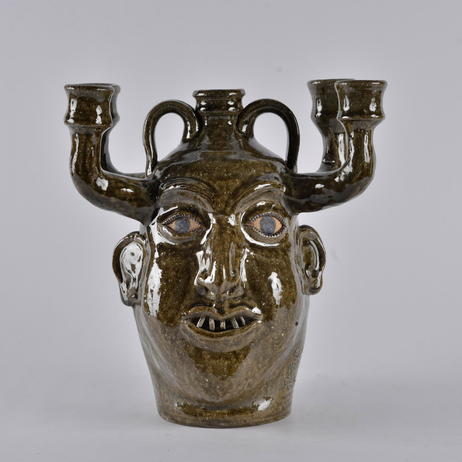 Clint Alderman Candelabra Double Face Jug: alkiline glaze, china teeth on both faces. Signed on base edge Mud Creek GA Feb. 2000 - Height 10.75"