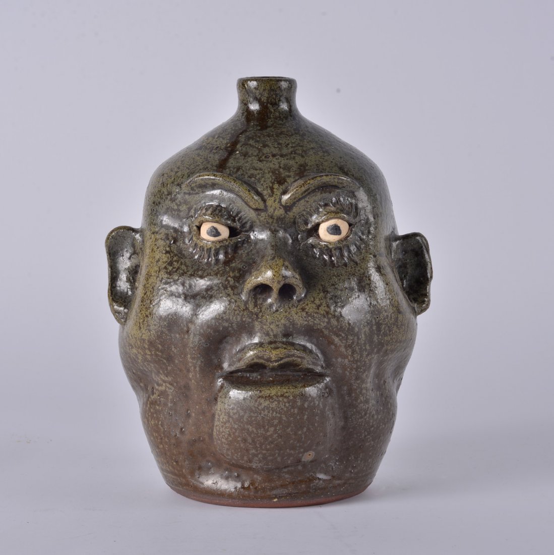 Lanier Meaders Face Jug NO TEETH: RARE NO TEETH face jug by Lanier Meaders. Great glaze and a fat face jug with molded eyebrows. NO TEETH is a rare feature for Lanier Face jugs to have. Height 10.5"