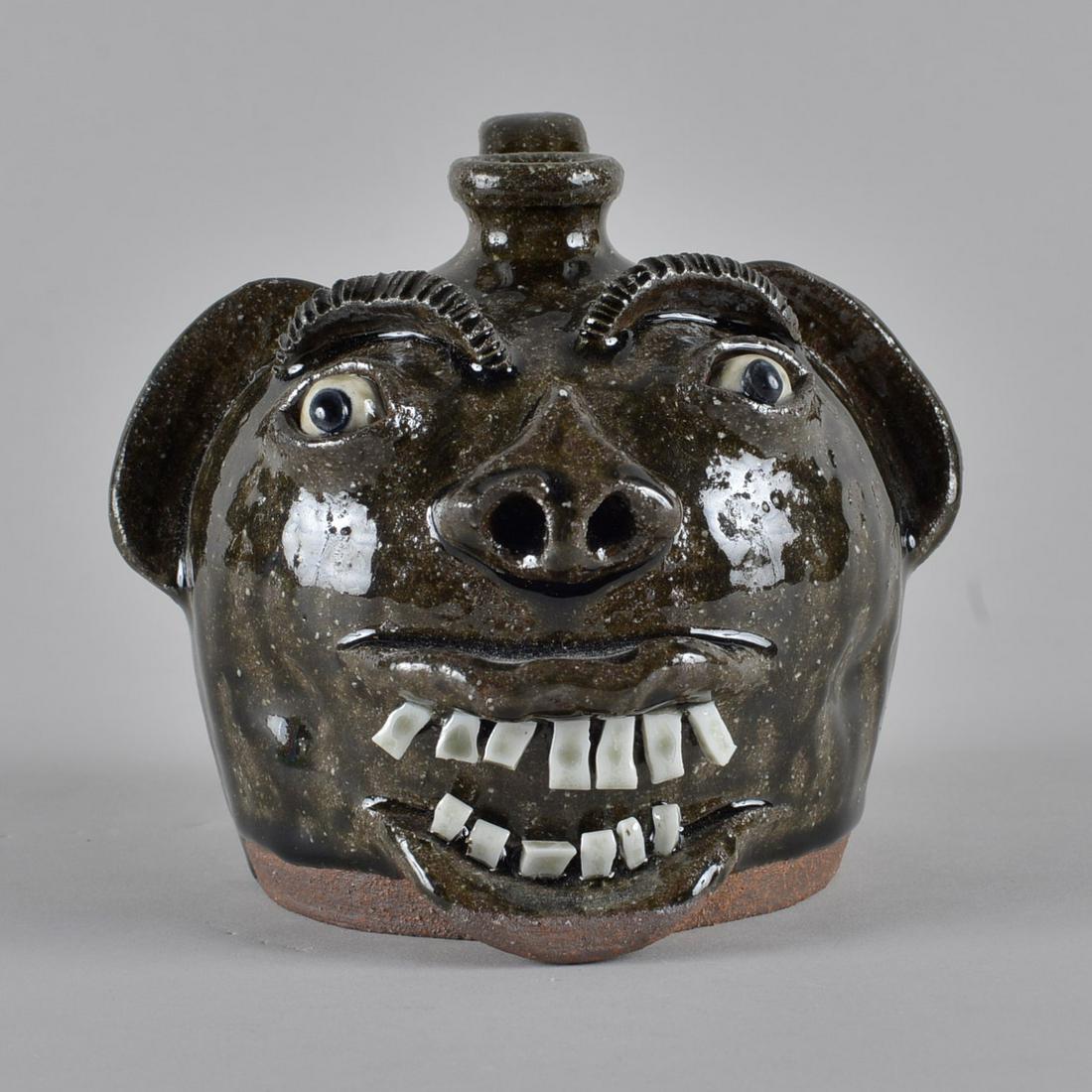 AV Smith Miniature Face Jug: alkiline glaze face jug double row of teeth. Signed AV SMITH on bottom. Height 4.75"