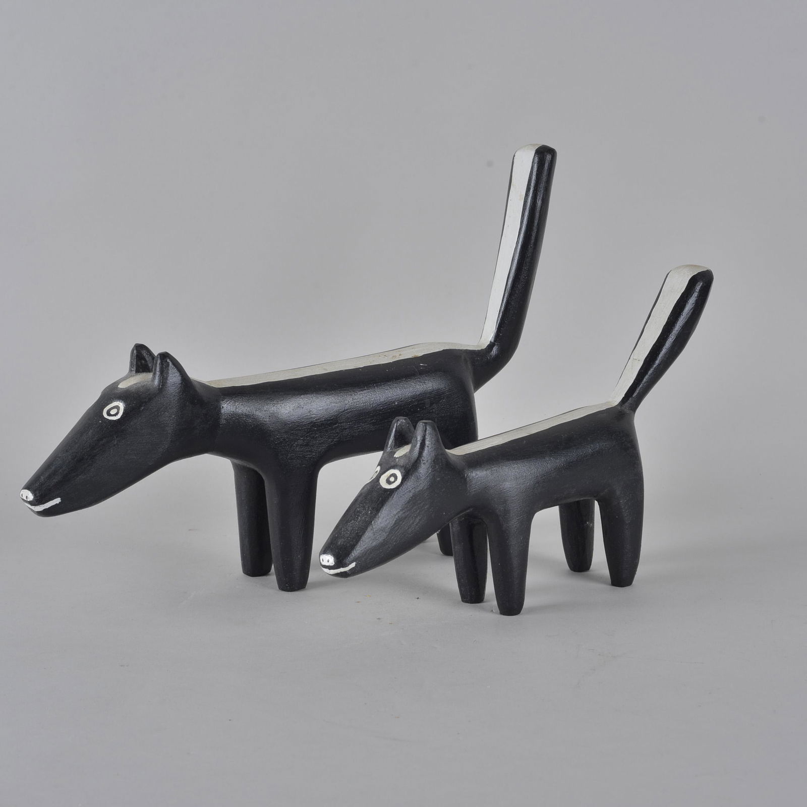 Charles Keeton folk art painted skunk pair: wood and paint. Unsigned. Charles worked with Minnie Adkins for a time period. Length 13" and 11"