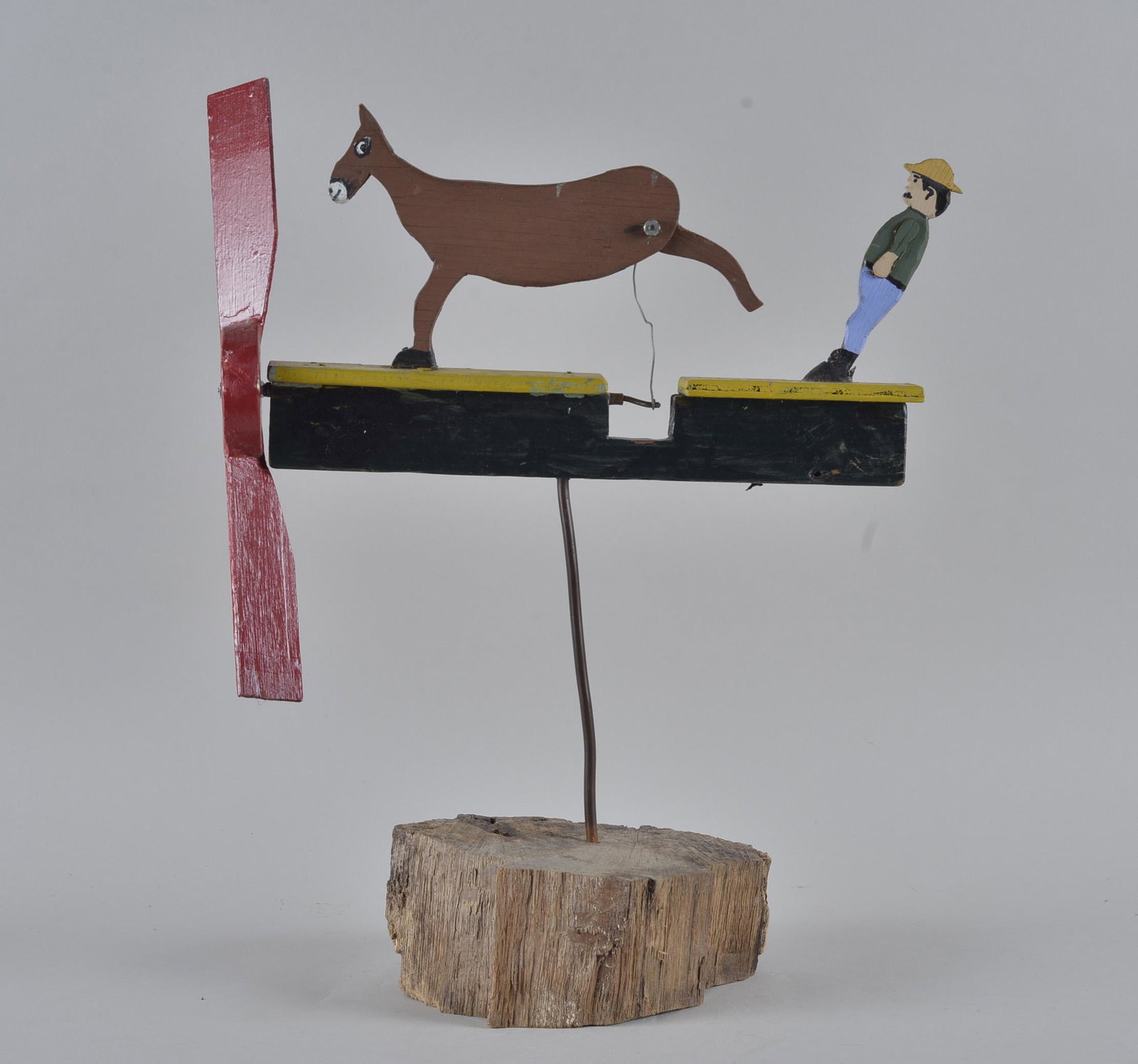 Folk Art Whirly Gig: mule kicking man. Whirly gig on base. Carved wood and paint.