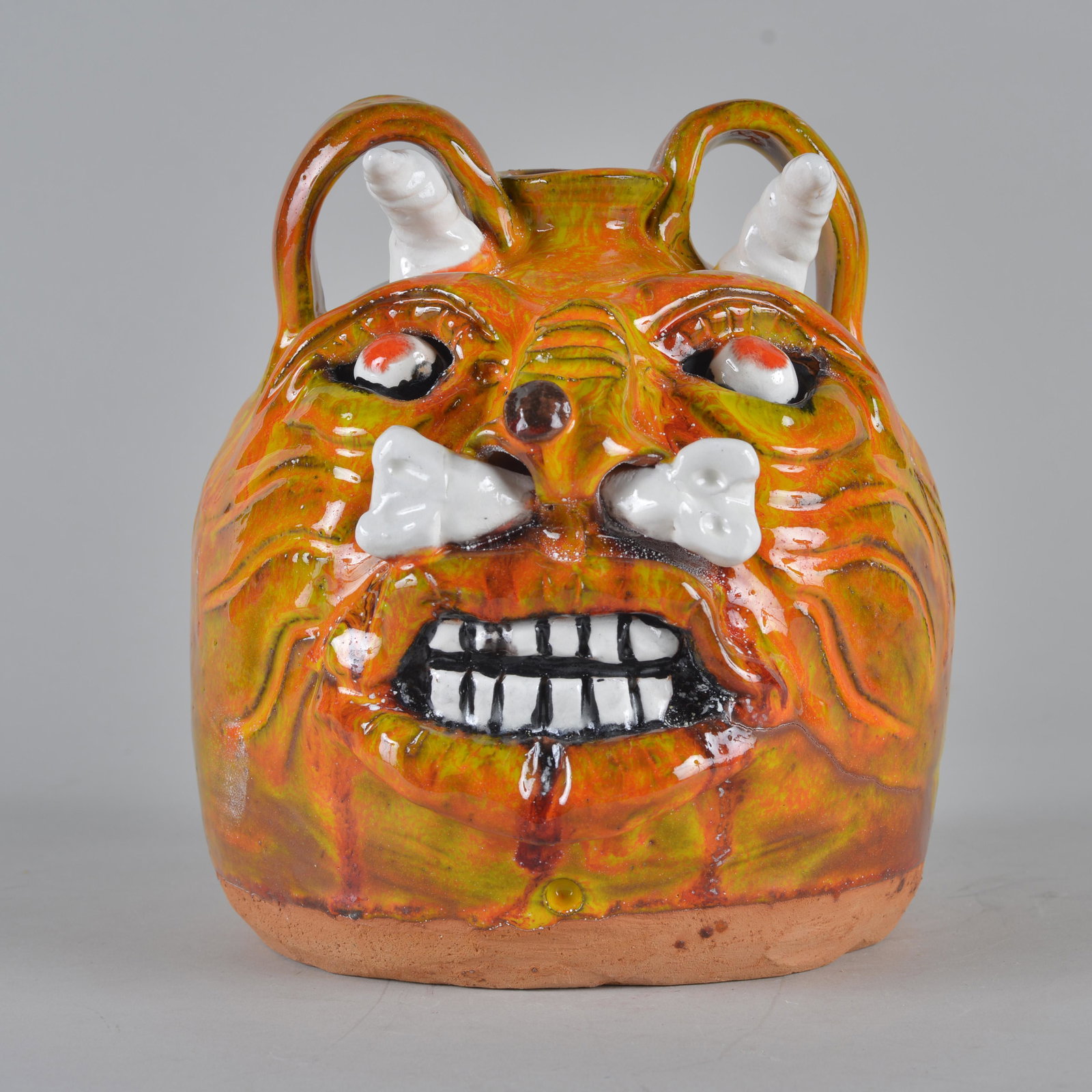 Mike Hanning Face Jug: multicolor glaze Devil Tiger with bone in nose signed and dated 9"