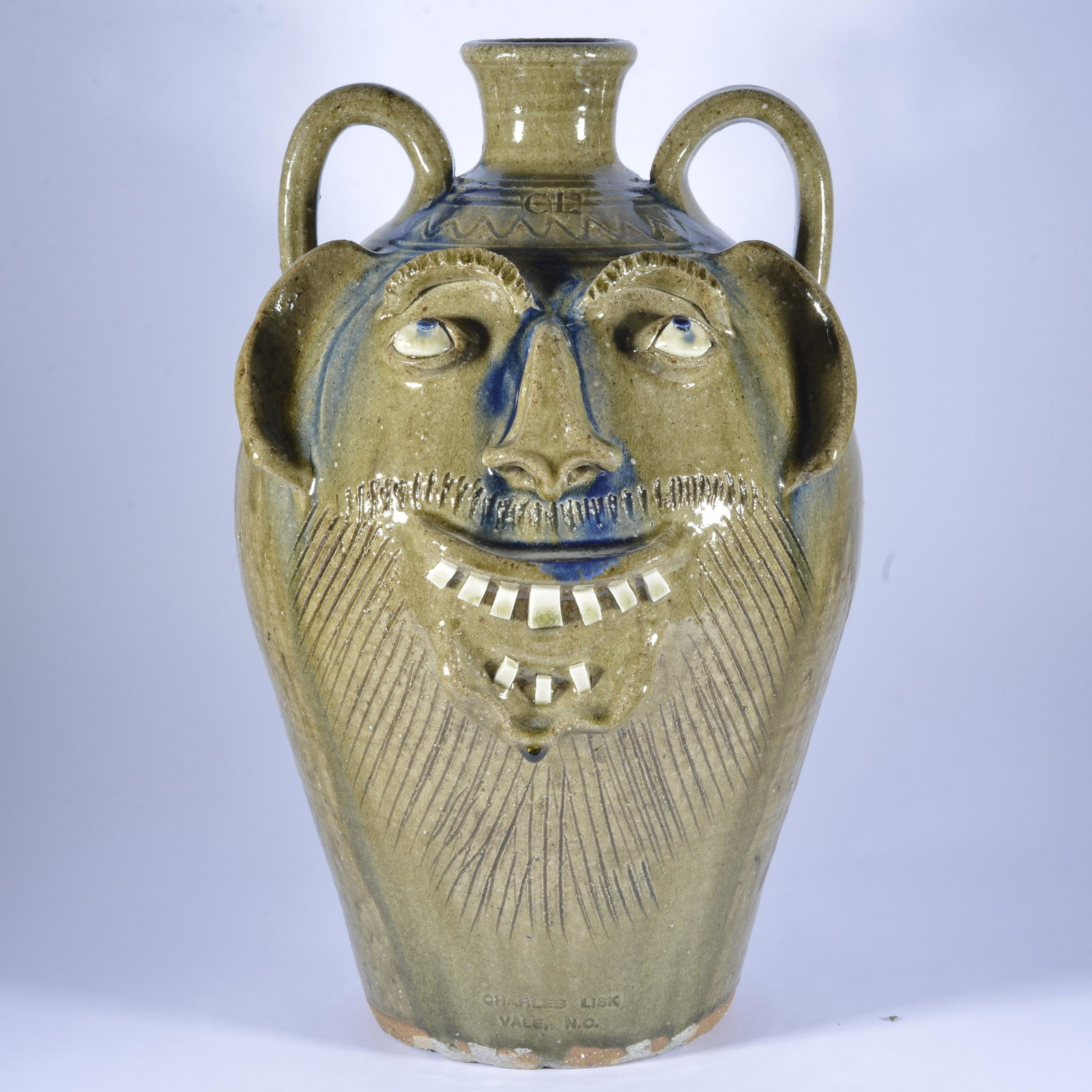 Charles Lisk face jug: China tooth double row signed/stamped on forehead and side signed on bottom Vale NC 16.5"H *** after further inspection of this face jug there is a tight hairline running across the middle of the face