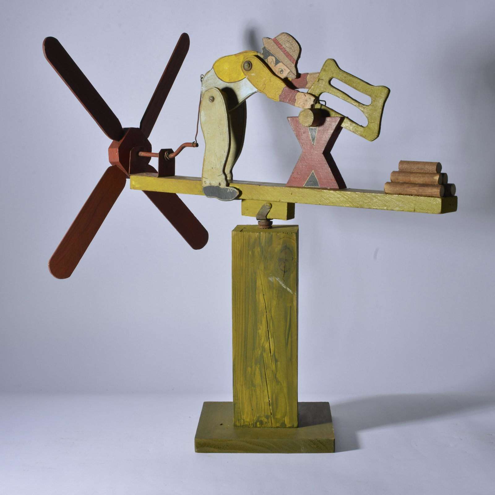 Folk Art Whirligig (sawing): wood and paint on artist made base. 22.25" H x 21" L