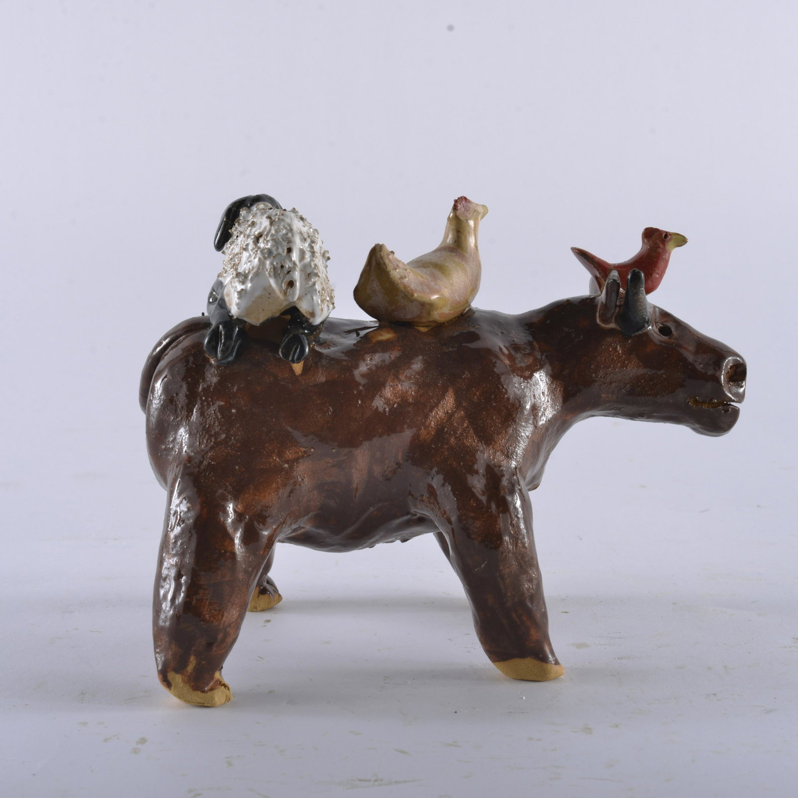 LYNN BAILEY COW FIGURAL: Lynn Bailey, Marvin's wife has great talent with the clay and makes wonderful folky animals. This is a great cow with animals on its back. 6.75"x5"