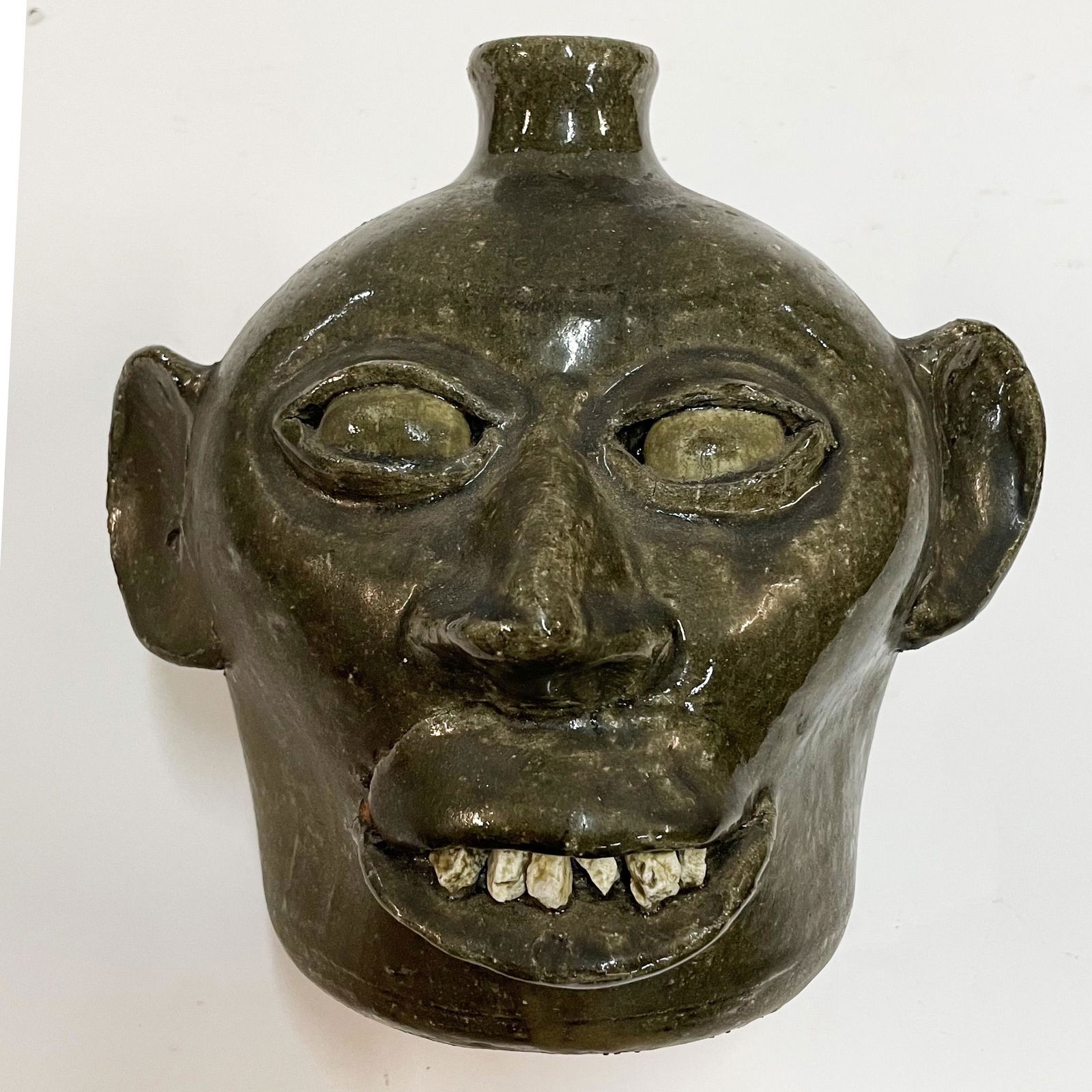 LANIER MEADERS ROCK TOOTH GLAZED EYE FACE JUG: Early Lanier Meaders with rock teeth and glazed eyes, circa 1970. Rare pinch face. A striking face jug that is fresh to the market from a private collection. Incredible clay eyeballs are so notable. S