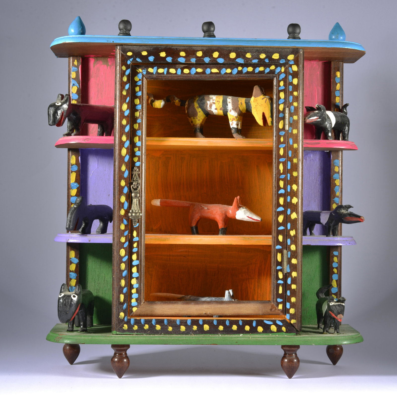 MINNIE ADKINS FOLK ART MINIATURE CABINET CARVING: 9 miniature carvings. Painted cabinet. Dated 1994 signed on top. 15"x14" - missing one small strip of wood on bottom and missing glass.
