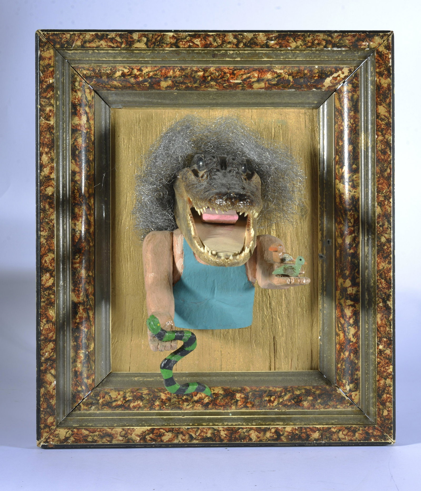 TOM "THE DEACON MAN" STECK FOLK ART: Folk art gator man. made from a real gator head. Small carved snake. Wood and paint. Framed ready to hang. Signed on back. 12.5"x15" alligator sticks out 7"