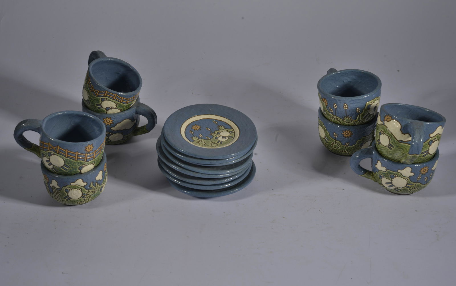 POTTERY TEA CUPS AND SAUCERS: POTTERY TEA CUPS AND SAUCERS. 5" saucers, 2.5" tall cups