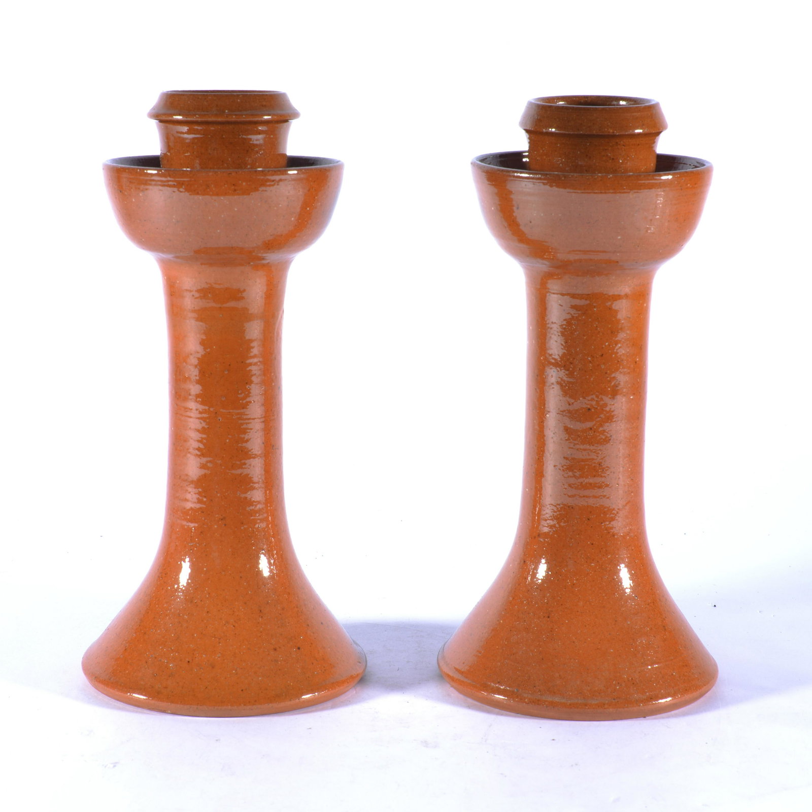 BEN OWEN MASTER POTTER PAIR OF CANDLESTICKS SEAGROVE NC 1960s: Both signed w/ Ben Owen's circular stamp on base. Lighter reddish tobacco spit glaze. 1960's. Both are 8.75" tall.