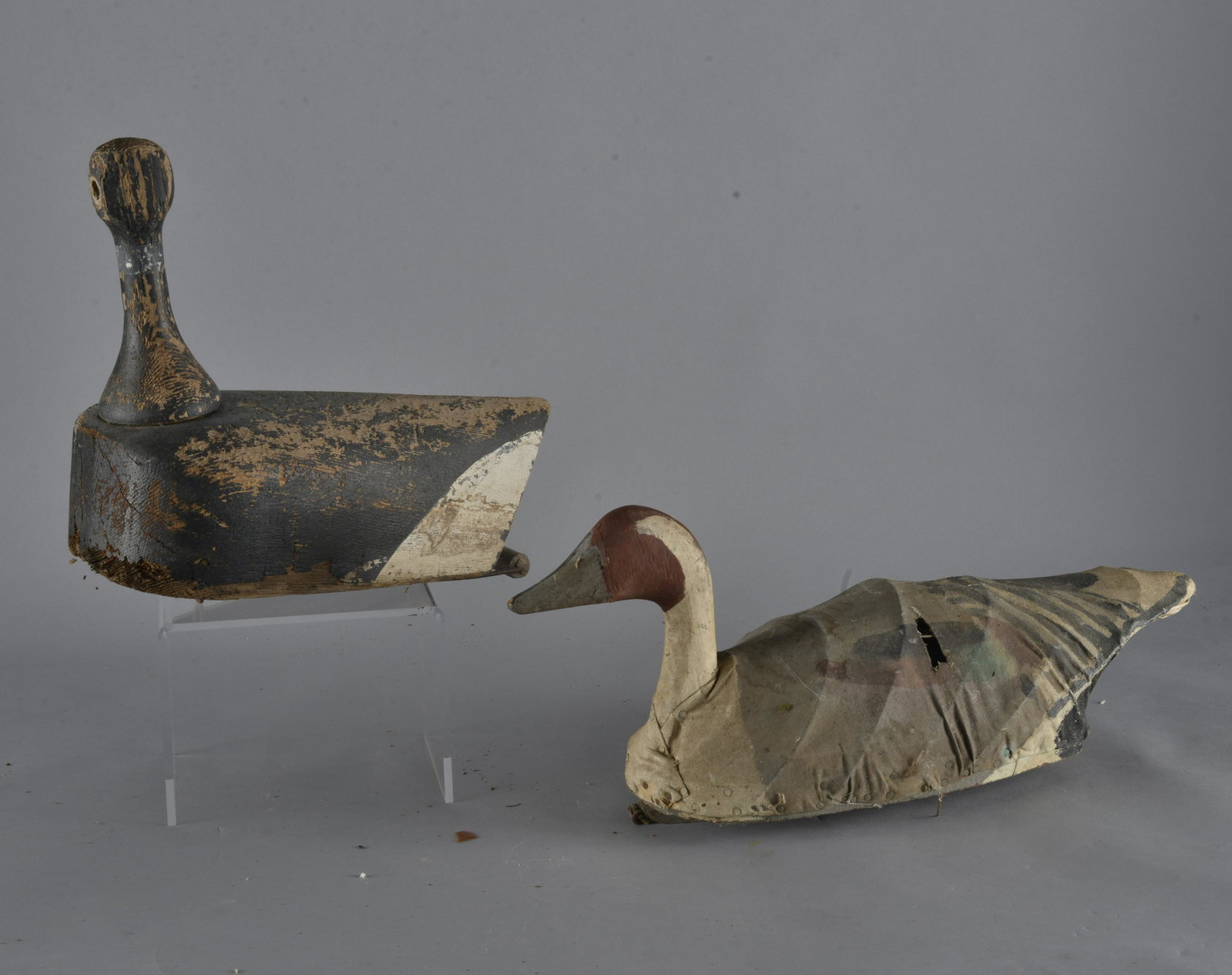 Antique Duck Decoy Group: carved wood and paint, and canvas and paint. Both have losses and need rehab- Length of canvas back 18" x 9" to top of head