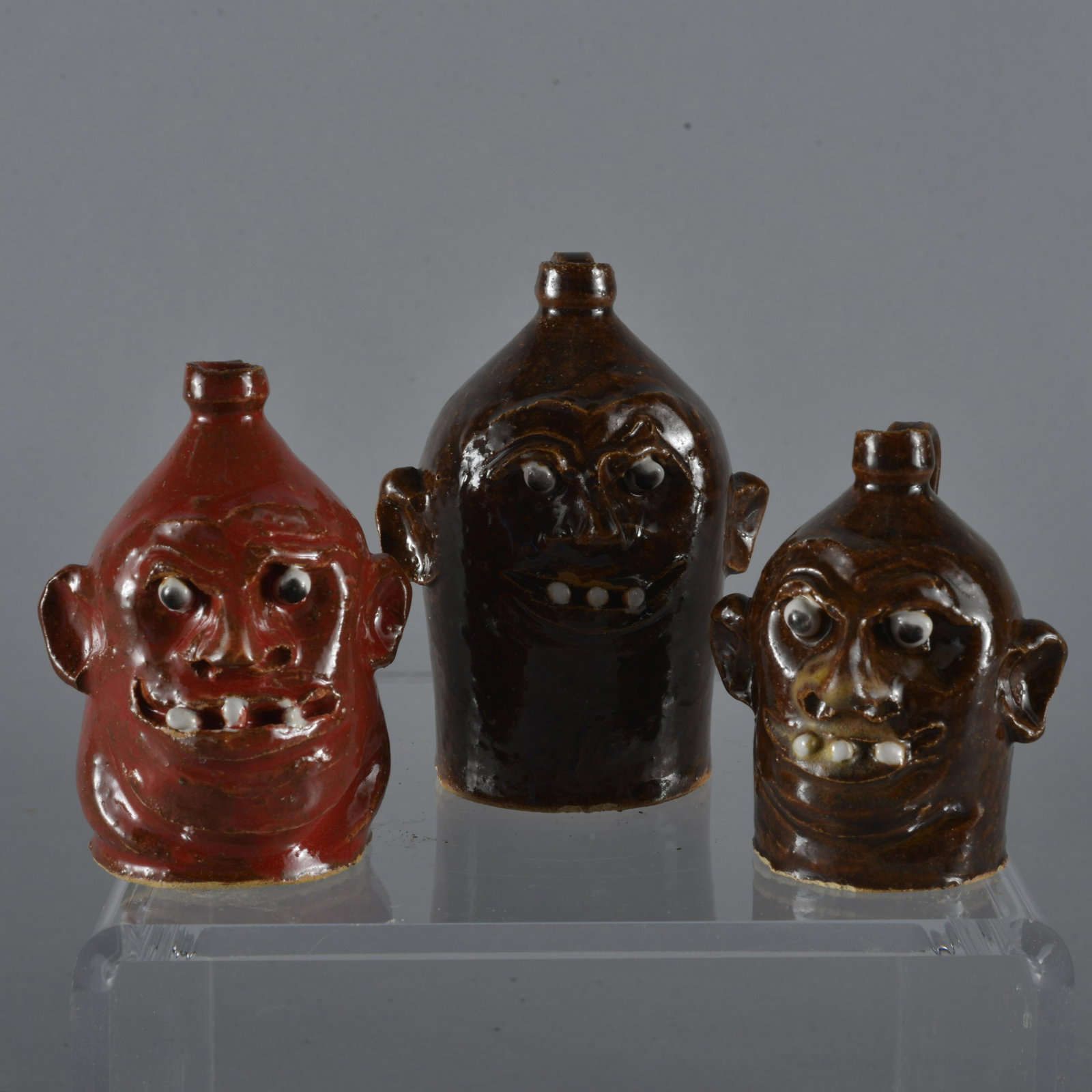 Marvin Bailey Mini Trio of Face Jugs Clay Teeth SC: Great group of mini face jugs by SC potter Marvin Bailey. They have clay teeth, clay eyes, and signed on base. They stand 3.75, 3.5, and 3.25" tall.