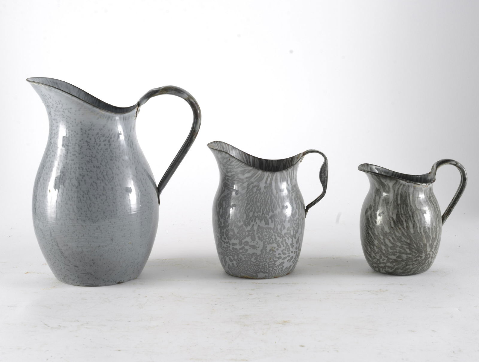 Three Piece Graduated Gray Mottled Enamelware Milk Pitchers (1 of 2)