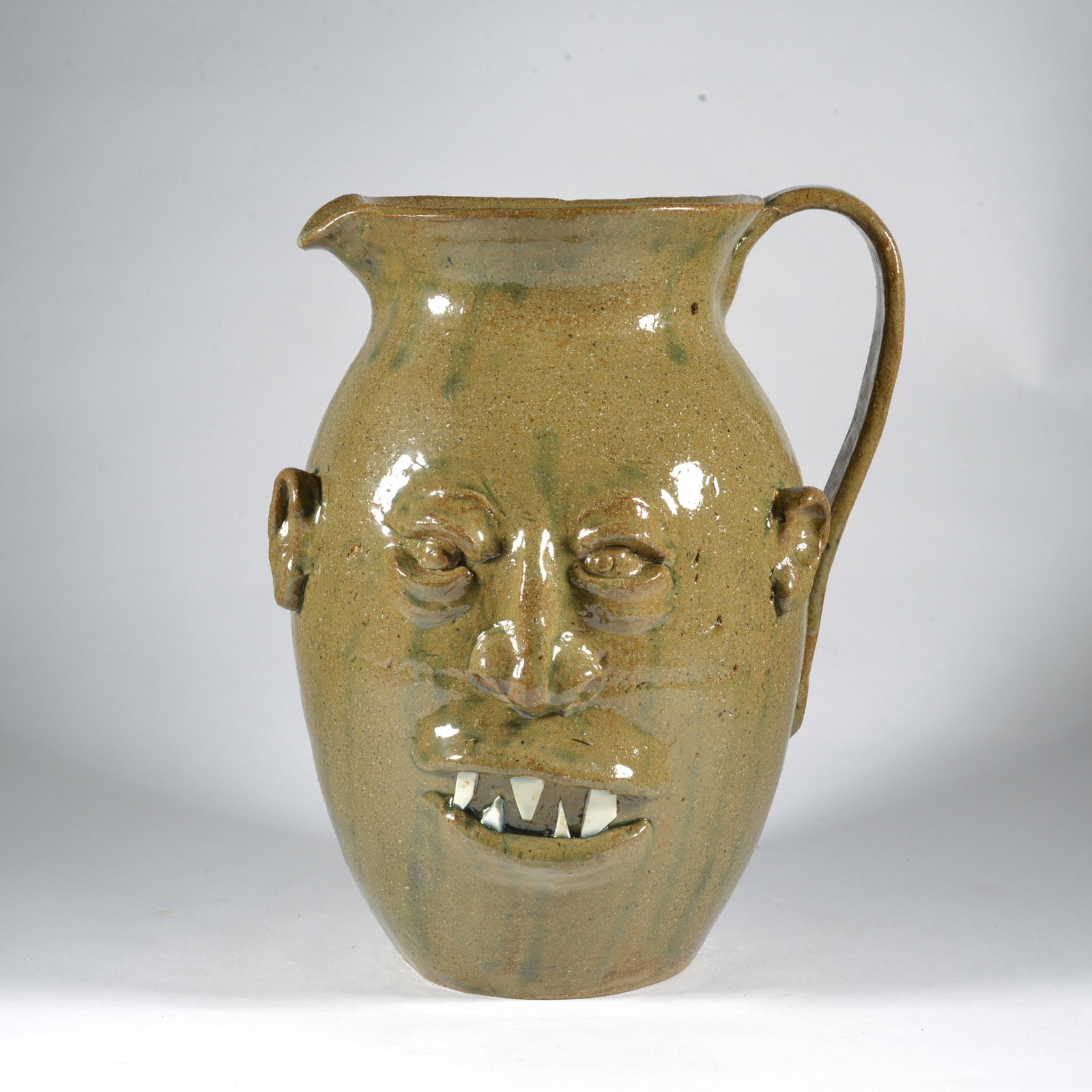 Roger Hicks Face Jug Pitcher Wood-Fired Catawba Valley NC Pottery: This is a classic form of pitcher/jug with face application by Catawba Valley potter Roger Hicks. He would put pots into a variety of fellow poa great glaze and perfect symmetry of form. His busts are
