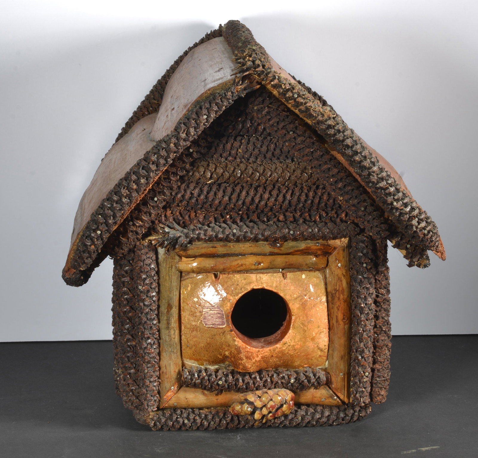 FOLK ART BIRD HOUSE: FOLK ART BIRD HOUSE WITH PINE CONES AND TREE BARK 9".5 X 9" X 11"