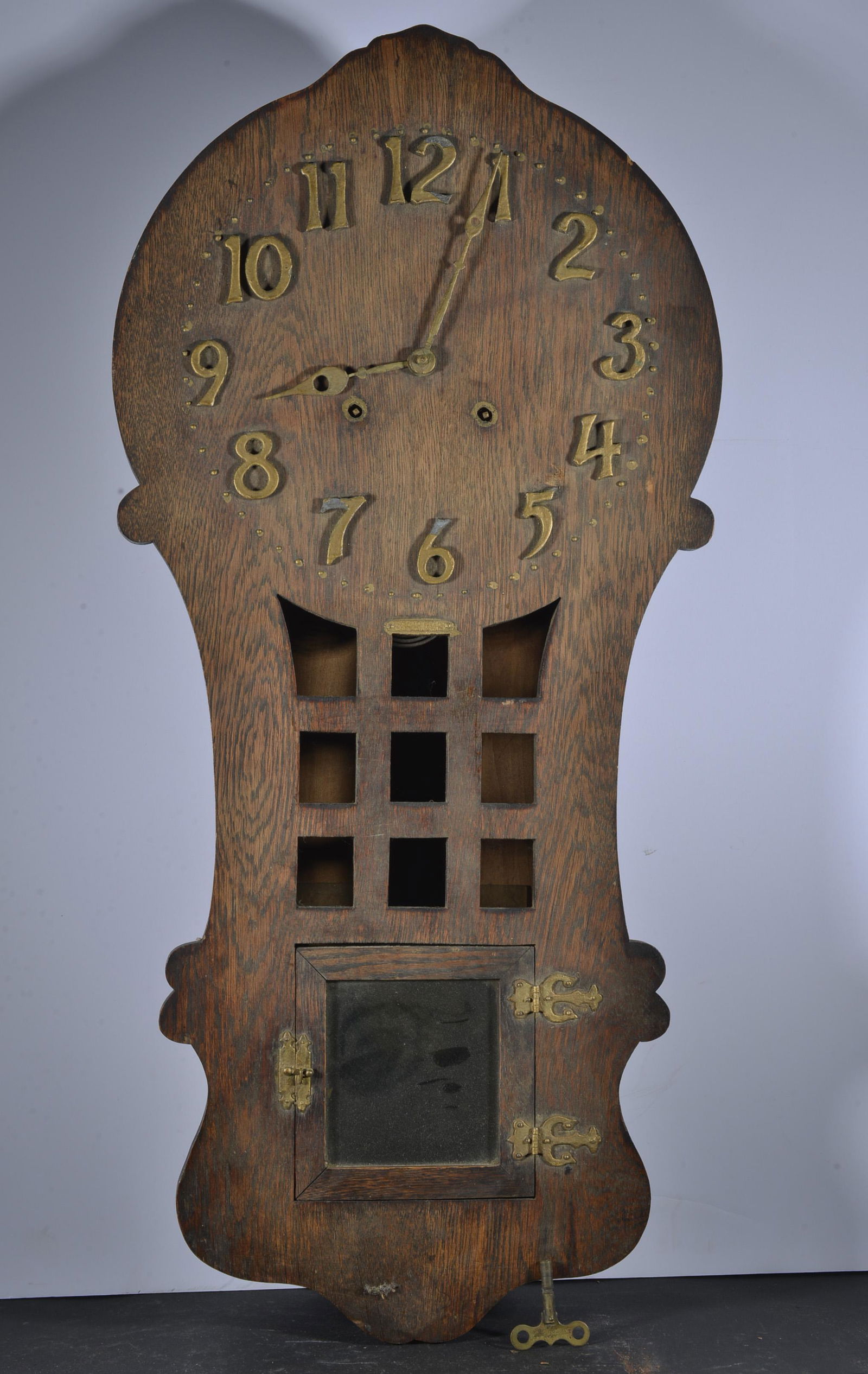 SESSION MISSION OAK STYLE WALL CLOCK: SESSIONS "RAMONA" MISSION OAK STYLE WALL CLOCK CIRCA 1910 31.5" X 15" X 4.25" APPLIED BRASS NUMBERS AND HINGES, EIGHT DAY TIME AND STRIKE MOVEMENT