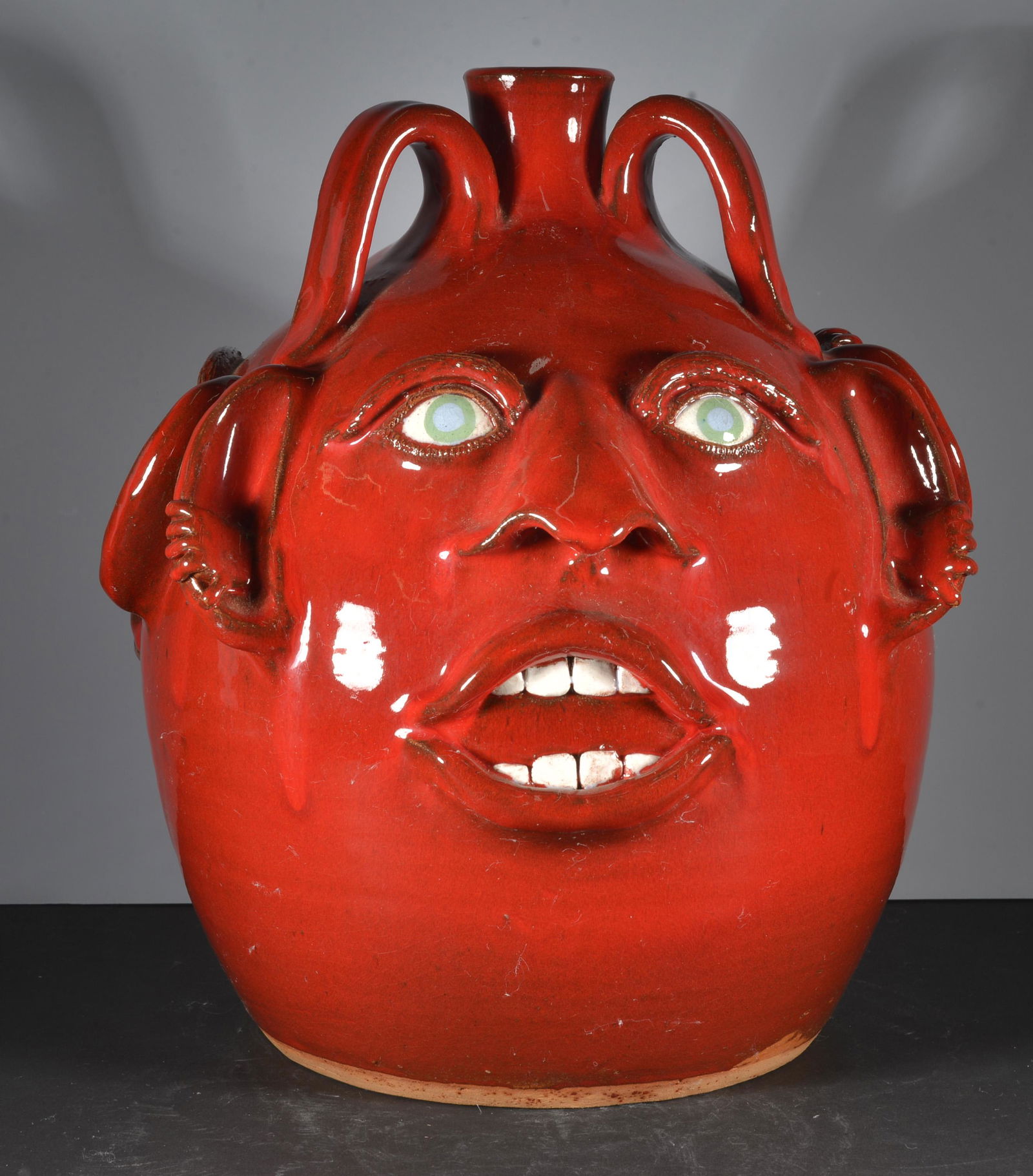 JOE REINHARDT POTTERY  RED GLAZE TRIPLE FACE JUG (1 of 5)