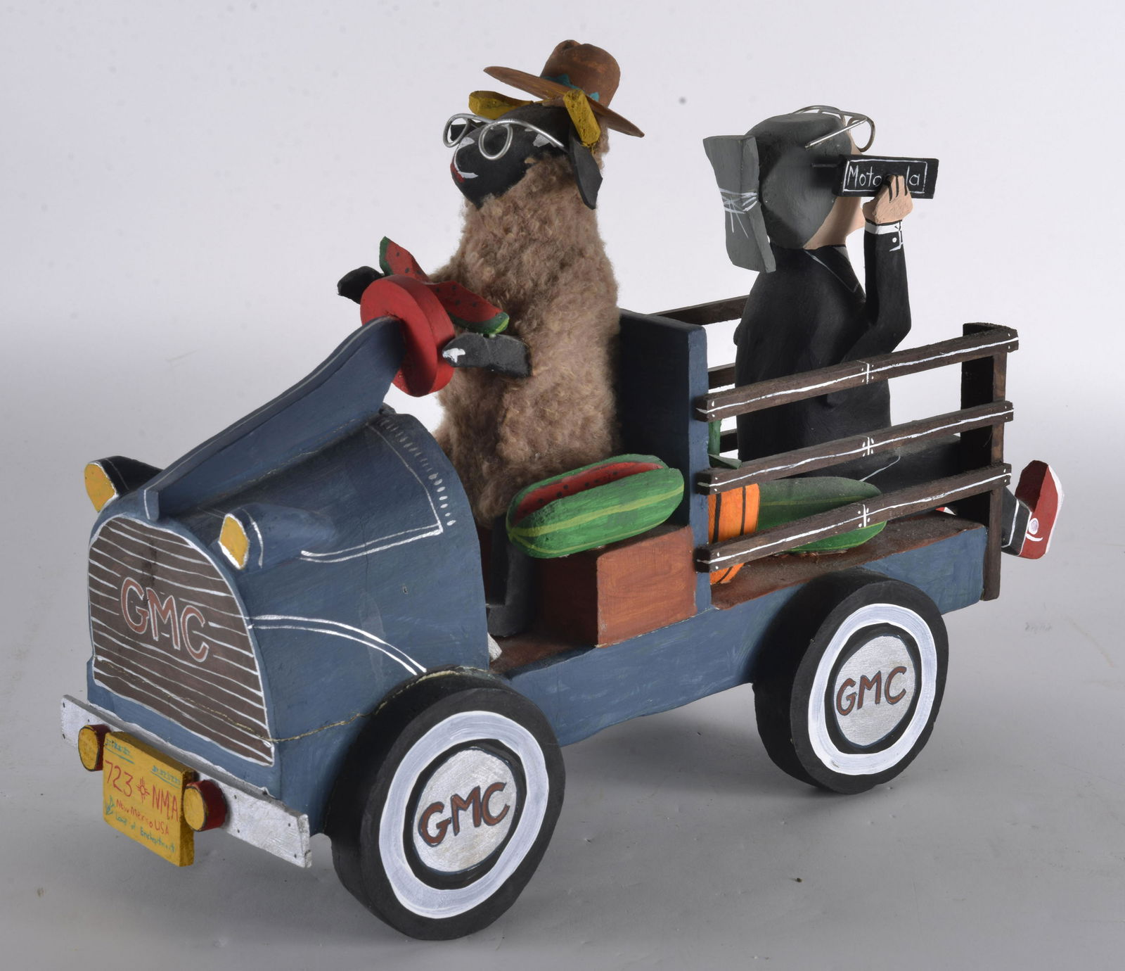 Delbert Buck Folk Art: Humorous folk art by Navajo wood carver. GMC STEAK TRUNK WITH PUIMPKINS AND WATERMELON 19" X 13"