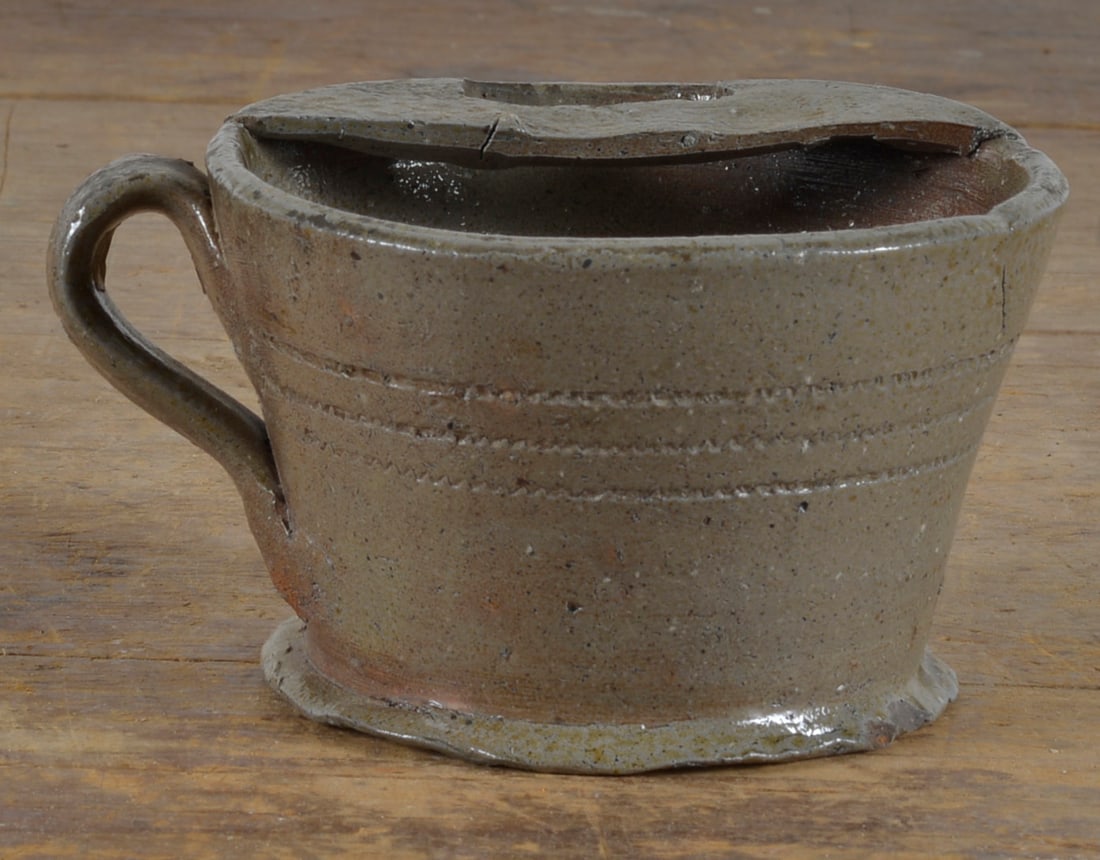 Important North Carolina Salt Glaze Mustache Cup: very rare and important salt glaze pottery circa 1850. From the shop of Dixon or Fox. Never seen this form before. A very rare example of utilitarian pottery. From the collection of Nancy Conover.2.5"